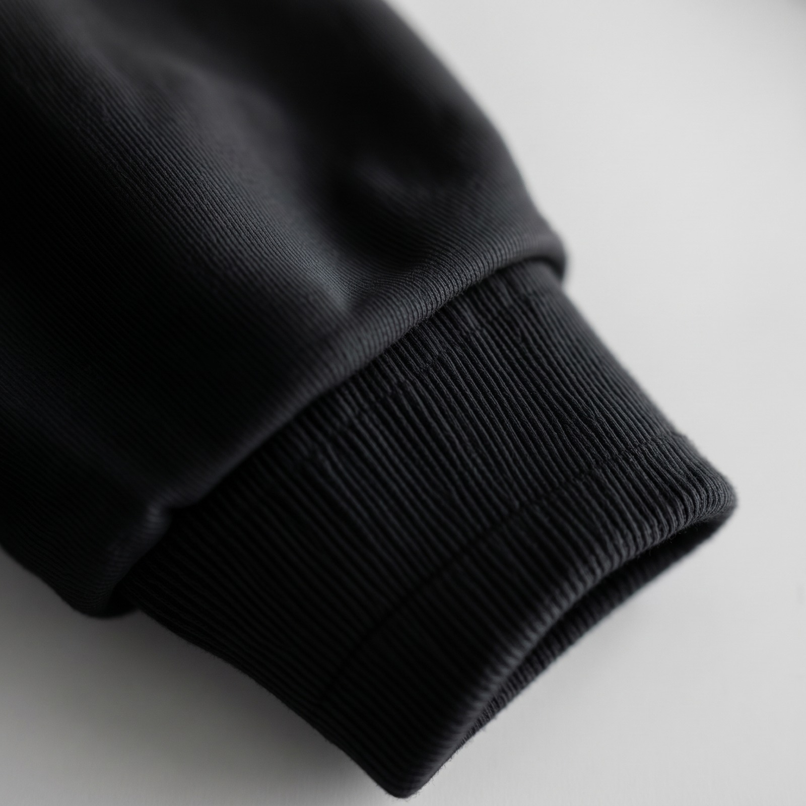 Close-up of black hoodie ribbed cuff